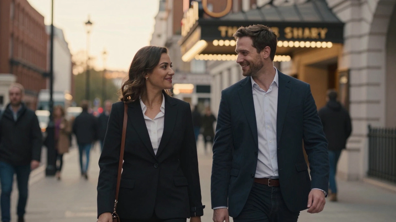 A man and woman walking together in Westminster at dusk, passing a theater, dressed for an evening out.