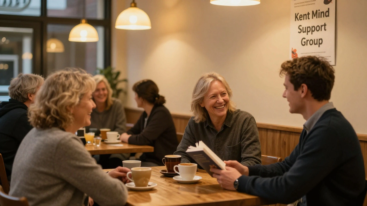 People socializing warmly in a Maidstone community center during an evening support group meeting.