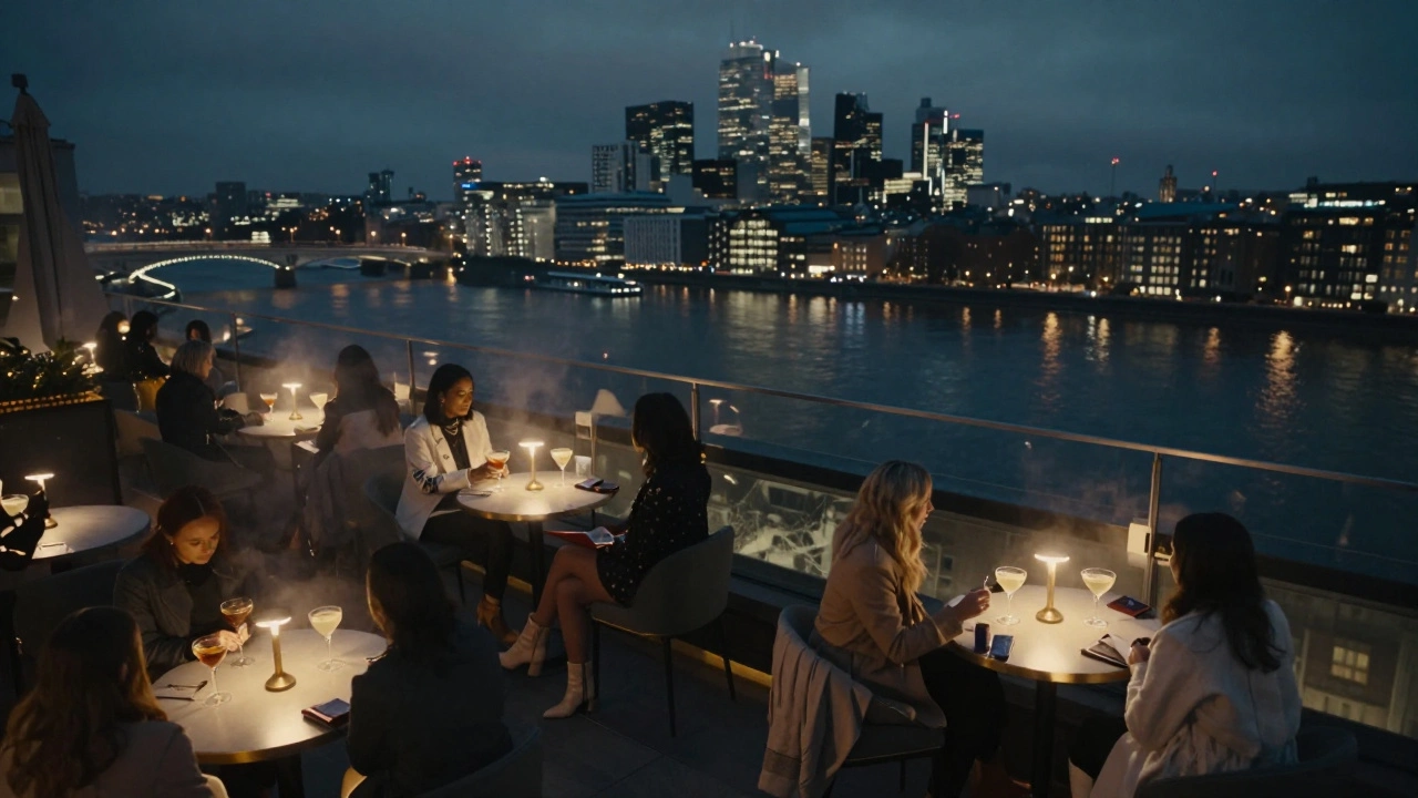 Women enjoying cocktails on a rooftop terrace with London’s skyline glowing over the Thames at night.